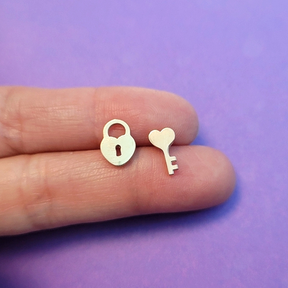Unique lock and key rose gold stainless steel earrings w/ metal push backings.